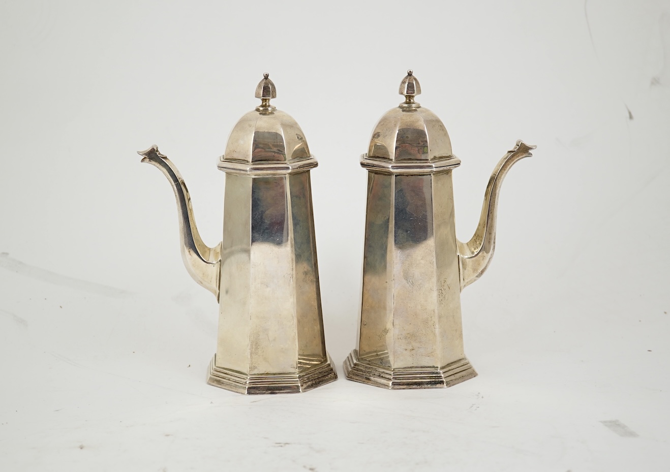 A pair of George V octagonal silver café au lait pots, by William Comyns & Sons Ltd